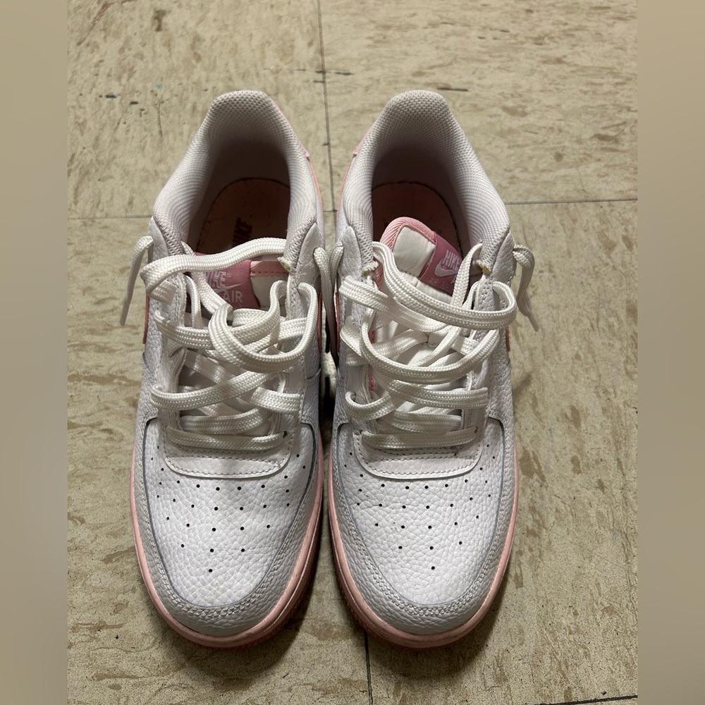 Pink and white Nike shoes